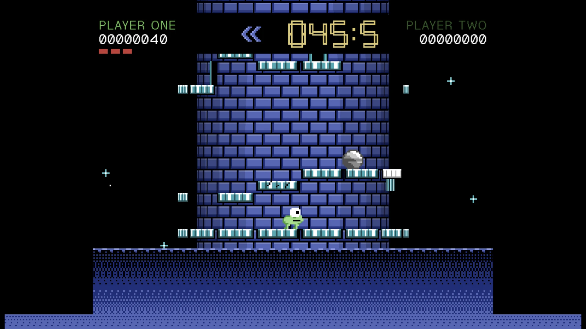 NEBULA TOWERS 64. A blue brick structure with platforms and green striped sections. A small green character stands on a lower platform while a white creature appears above, with the timer showing 045:5 and PLAYER ONE's score of 00000040 displayed at the top left. Taken for the update Mare alto.